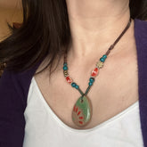 Handmade Ceramic Necklace with Artisanal Sunburst Pendant Bohemian Vintage Style Earthy Green & Orange Hues Brown like Cord for Casual Attire & Unique Gift Women's Fashion Jewelry Gift Accessory Ethnic Style Accessory Turquoise Colored Beads