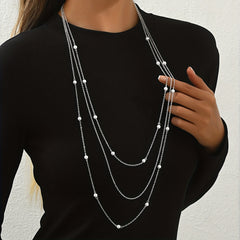 A Stylish And Elegant Three Layer Faux Pearl Long Necklace for Autumn And Winter Featuring a Geometric Trendy Design Suitable for Women to Wear on a Daily Basis for Commuting Parties Dates Music Festivals And More.
