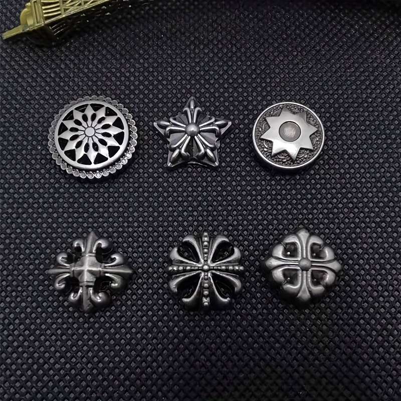 A set of four gold accessories, including a cross, a six-pointed star, a vintage belt, and five gold hardware accessories such as rivets and studs. Styles are sent randomly