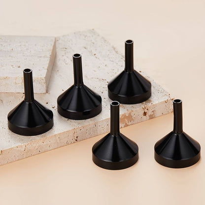 A set of small gold funnels designed specifically for perfumes and essential oils, making it easy to transfer and pour various liquids.