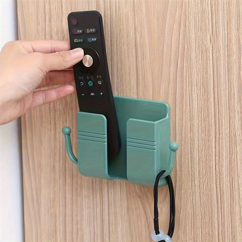 One adhesive wall mount with hooks, perfect for holding phone chargers and remote controls.