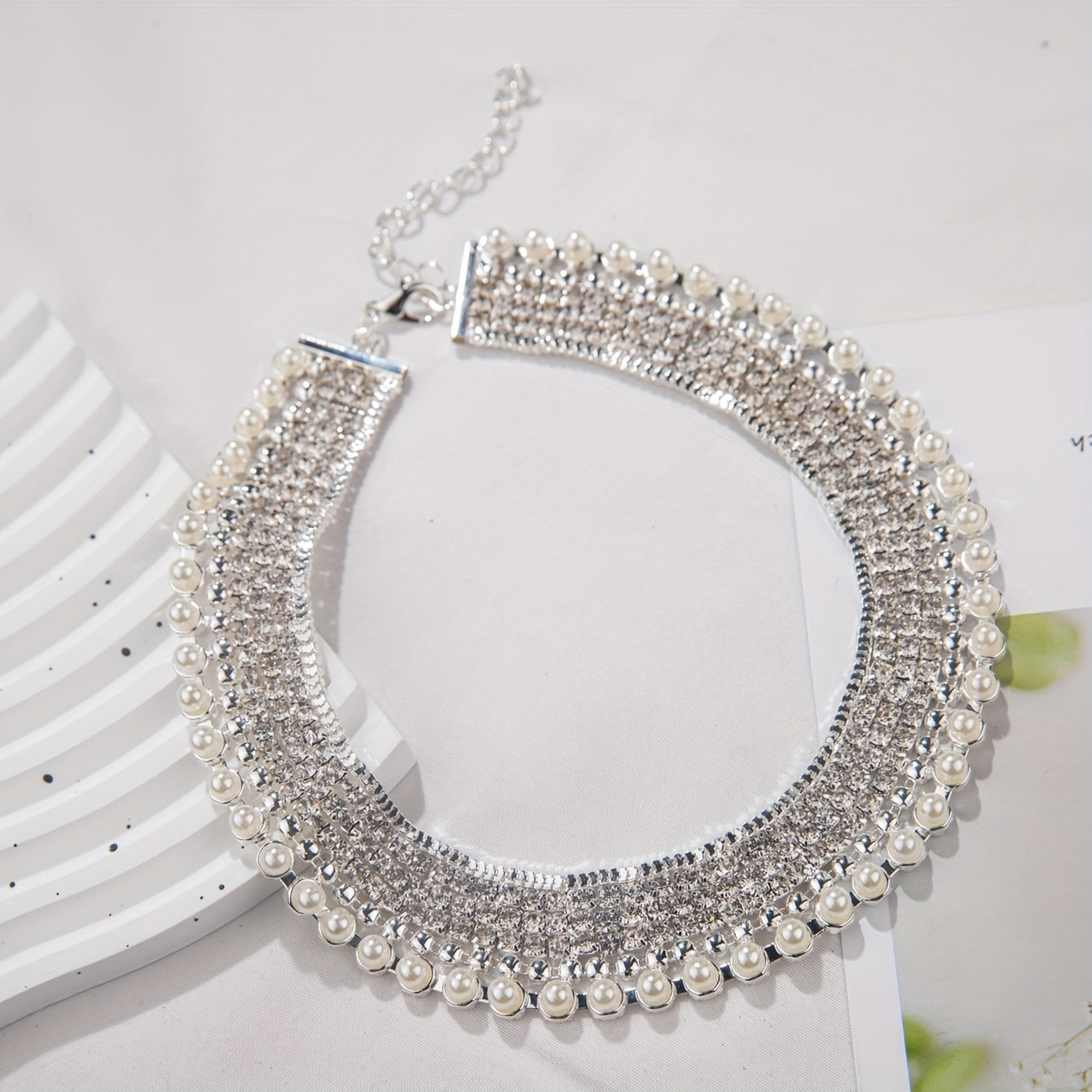 An exaggerated rhinestone and faux necklace suitable for daily wear by women